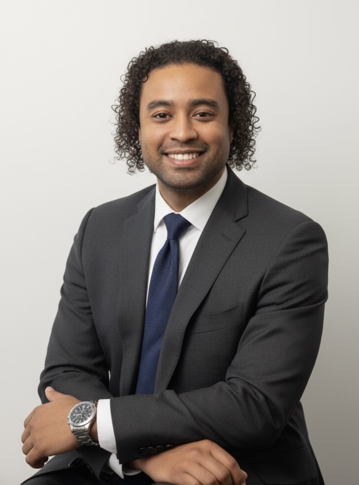 Jimmy Thomas, founder of Thomas & Runtulalo Co., in a charcoal suit and navy tie.