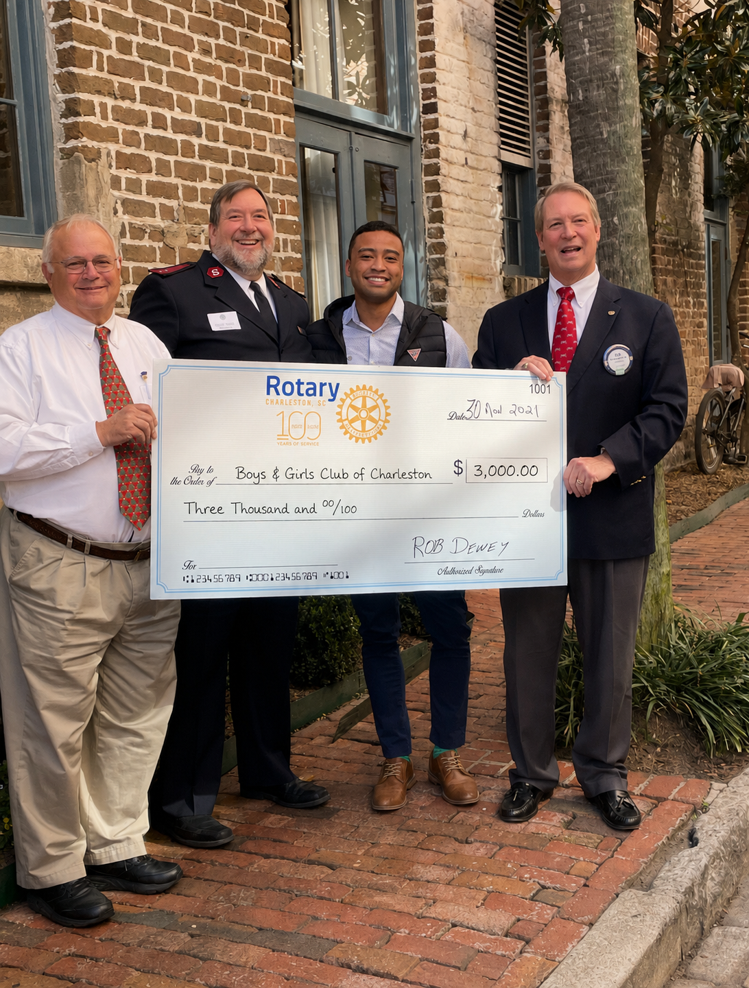 Rotary Club of Charleston members with an oversized presentation check payable to the Boys & Girls Club of Charleston.