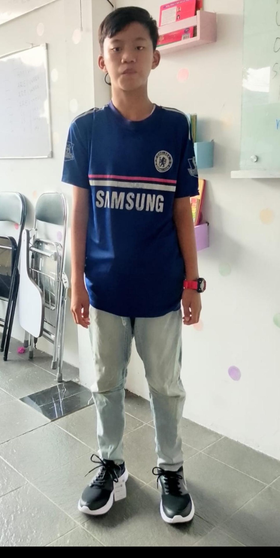 A student in Indonesia wearing new school shoes provided through the back-to-school project.